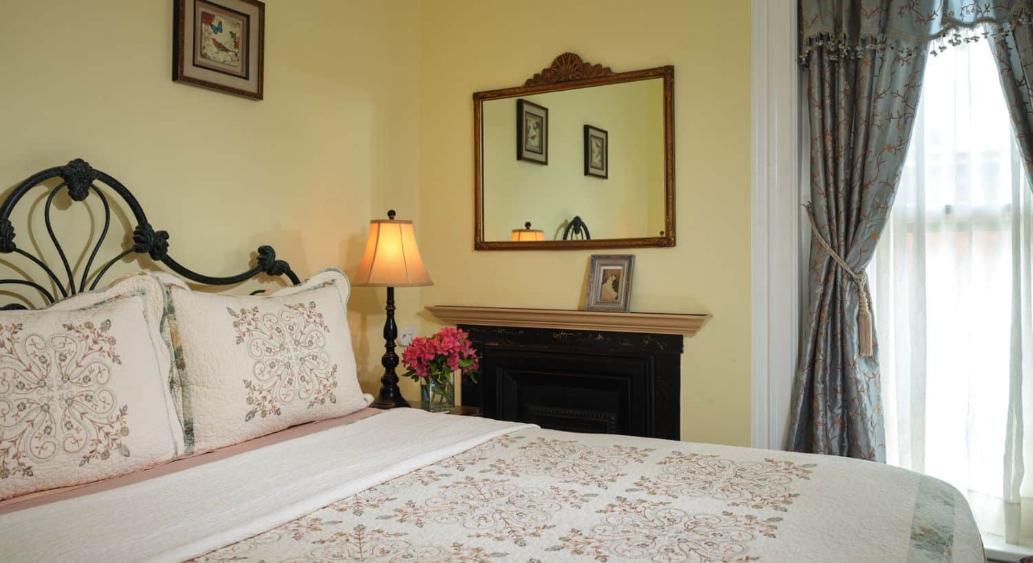 Comfortable guest room with fireplace and natural light at Spencer House Bed and Breakfast in Erie, Pennsylvania