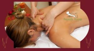 A blonde Woman laying face down on a massage table getting a massage