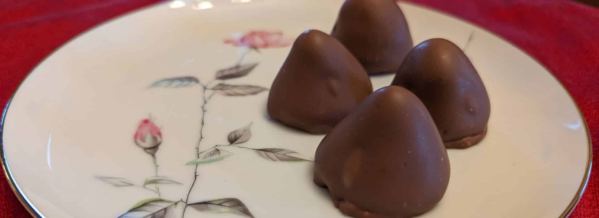 Close up view of chocolate covered strawberries on a white porcelain plate